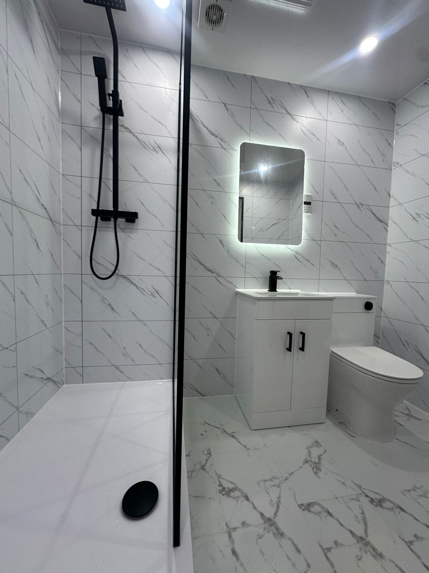 A completed U Bathroom Solutions marble-effect bathroom